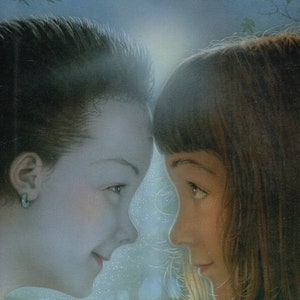 May include: Book cover with the title "SOLAY" in large, red letters. The cover features a close-up of two children's faces, a boy and a girl, looking at each other. The background is a soft blue with a green path and trees.