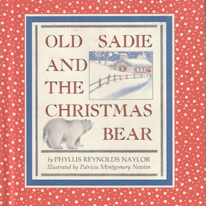 May include: A hardcover book titled Old Sadie and the Christmas Bear by Phyllis Reynolds Naylor, illustrated by Patricia Montgomery Newton. The cover features a red background with white dots, a bear illustration, and a snowy cabin scene.