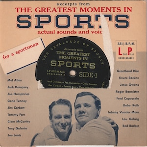 May include: A black and white record with the text "The Greatest Moments in Sports" and a picture of two men. The record is labeled "Side 1" and has a list of famous athletes on the back.
