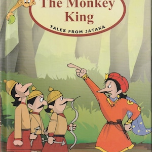 May include: An illustrated book cover featuring a monkey holding a green fruit, with the title "The Monkey King Tales from Jataka" in a red oval. The cover also shows three men in yellow hats and red tunics, and a man in a red tunic and turban pointing to the left.