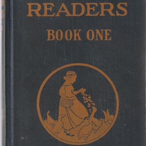 May include: A black book cover with the title "The Elson Readers Book One" in orange text. The cover features an illustration of a woman in a long dress feeding birds from a basket.