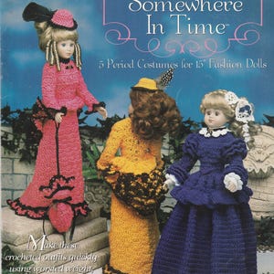 May include: A crochet pattern book titled Somewhere In Time Vol. 1 featuring 5 Period Costumes for 15" Fashion Dolls. The cover displays three dolls wearing long, detailed crocheted dresses in pink, yellow, and dark blue with matching hats.
