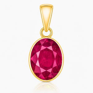 May include: An oval-shaped pendant featuring a faceted deep red gemstone set in a polished yellow gold bezel. The pendant includes a tapered gold bail at the top, designed for attachment to a chain, showcasing a classic and symmetrical design.