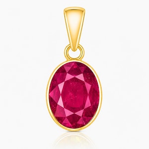 May include: An oval-shaped pendant featuring a faceted deep red gemstone set in a polished yellow gold bezel. The pendant includes a tapered gold bail at the top, designed for attachment to a chain, showcasing a classic and symmetrical design.