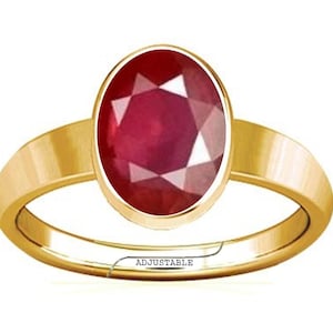 May include: A gold ring featuring a large, oval-shaped, red ruby gemstone. The ring is adjustable.