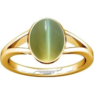 May include: A gold-colored ring featuring an oval, light green gemstone. The ring has a split shank design and the word "ADJUSTABLE" is printed on the band. The gemstone has a cat's eye effect.