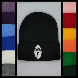 May include: Black beanie with a white embroidered ghost face design.