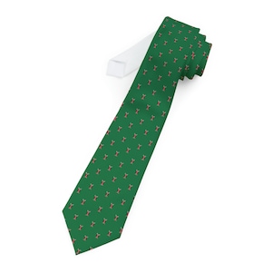 May include: A green tie with a repeating pattern of red and black figures.