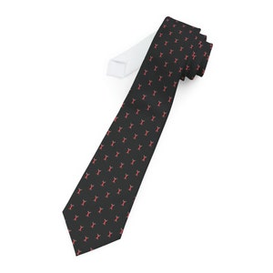 May include: A black tie with a repeating pattern of red lobsters. The tie is folded and tied in a knot.