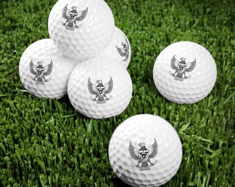 May include: Five white golf balls with a black and white eagle design on each ball. The eagle design includes the words "INDONESIA" and "MERDEKA".