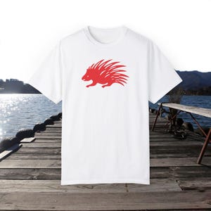 May include: White t-shirt with a red silhouette of a porcupine on the front.