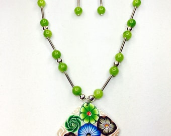 Handmade Necklace and Earring Set. Polymer Clay Pendant . Blue, Green and Black Flower motif.