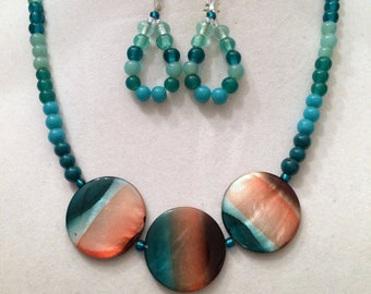 Handmade Necklace and Earring Set. Focal Beads are Shell in Shades of Teal and Coral. Beads are Glass in shades of Teal.