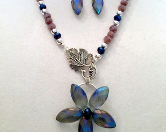 Handmade Necklace and Earring Set. Iridescent Blue Faceted Glass Teardrops form the Flower Pendant. Cloudy Amethyst, Blue and Silver Beads.