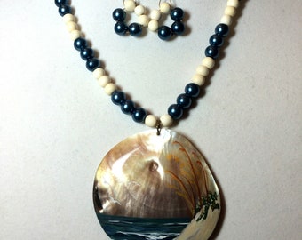 Shell Pendant with Hand Painted Beach Scene signed by the artist. Handmade Necklace and Earring Set. Dark Blue & Off-White Beads.