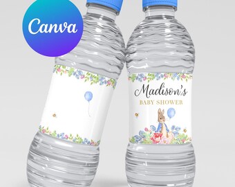 May include: Two clear plastic water bottles with blue lids and personalized labels. The labels feature a floral design and a cartoon bunny holding a blue balloon. One label reads "Madison's Baby Shower".