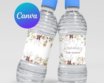 May include: Two clear plastic water bottles with blue caps and floral labels. The labels have a white background with a floral design and the text "Daniella's Baby Shower".
