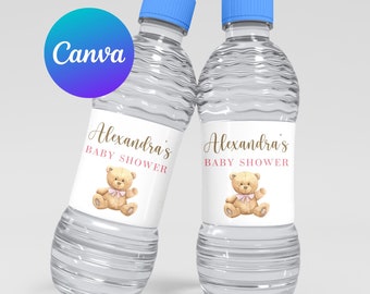 May include: Two clear plastic water bottles with blue lids and personalized labels. The labels are white with a pink and gold design featuring a teddy bear and the text "Alexandra's Baby Shower".