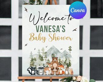 May include: A baby shower welcome sign on an easel. The sign reads "Welcome to Vanesa's Baby Shower" with a forest animal illustration. The design includes a bear, fox, deer, owl, and other woodland creatures.