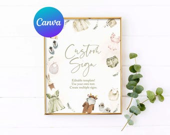 May include: A printable sign with a gold frame and a white background. The sign has the text "Custom Sign" in a handwritten font. The sign is decorated with watercolour illustrations of baby clothes, shoes, and a bunny rabbit. The text below the title reads "Editable template! Use your own text. Create multiple signs."