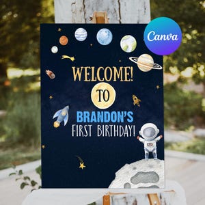 May include: A blue and black welcome sign with a space theme. It says "Welcome to Brandon's First Birthday!" with planets, stars, and a rocket ship. An astronaut is standing on the moon.