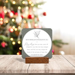 May include: A gray and white card with a floral design and the text "Doctrine & Covenants 10.5" and "Pray always that you may come off conqueror, yea, that you may conquer Satan, and that you may escape the hands of the servants of Satan that do uphold his work."
