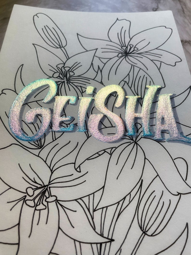 May include: A white background with black line drawings of lilies. The word "GEISHA" is written in iridescent blue and pink letters.