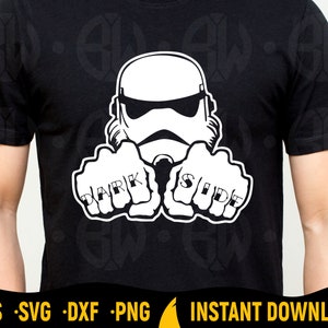 May include: Black t-shirt featuring a white graphic of a Stormtrooper helmet and fists. The fists are tattooed with the words "DARK" and "SIDE". The shirt has a crew neck and short sleeves. The bottom of the shirt has the words "EPS SVG DXF PNG" and "INSTANT DOWNLOAD".