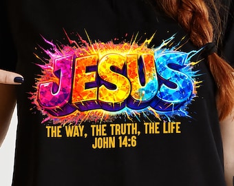 May include: Black t-shirt with the word "JESUS" in colourful 3D block letters. Underneath, the text reads "THE WAY, THE TRUTH, THE LIFE JOHN 14:6" in yellow. The design has a burst effect, with a vibrant colour palette.