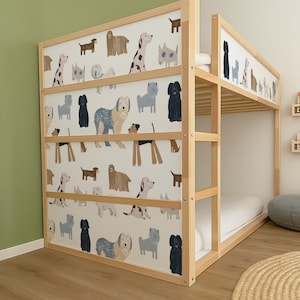 May include: A wooden bunk bed with a playful dog-themed design. The bed features a light-colored wood frame and panels adorned with various dog illustrations in shades of brown, gray, and black against a white background. The bed is designed for children.