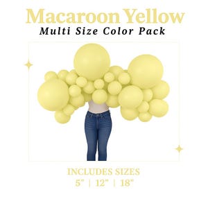 May include: A collection of yellow balloons in various sizes, arranged in an arch shape. The text "Macaroon Yellow Multi Size Color Pack" is displayed at the top. The sizes are 5", 12", and 18". A person is wearing blue jeans and a white top.
