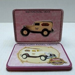 May include: Two vintage tin boxes with a white 1932 Ford panel truck on a pink background. The top box has the text "1932 Ford Panel Truck" and the bottom box has the text "1932 Ford Panel Truck" and "Complete 75 Years of Car Collecting 1928-2003".