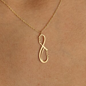 May include: A gold infinity symbol necklace with the name "Jennifer" inscribed inside the symbol.