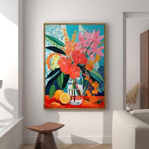May include: A framed painting of a still life featuring a glass vase filled with pink and orange flowers, a sliced orange, and green leaves on a red background.