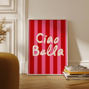 May include: A framed print with a red and pink striped background and the text "Ciao Bella" in white.