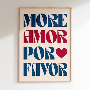 May include: A beige framed print with the text "MORE AMOR POR FAVOR" in blue and red lettering with a red heart symbol.