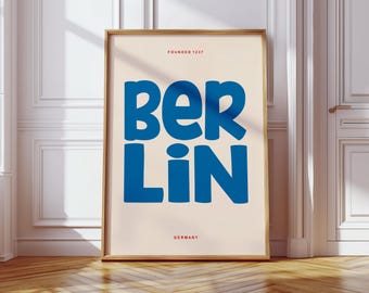 May include: A poster with a light beige background and a gold frame. The poster features the word "Berlin" in large, blue, bubble-like letters. The text "Founded 1237" appears in red above the word "Berlin". The text "Germany" appears in red below the word "Berlin".