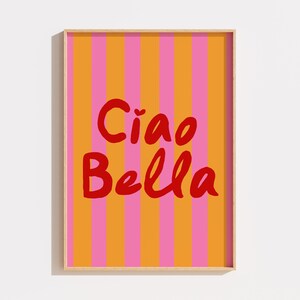 May include: A framed print with a striped background in orange and pink. The text "Ciao Bella" is written in red.