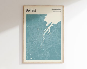 May include: A blue and white map print of Belfast, Northern Ireland. The map shows the city's streets and landmarks. The text "Belfast" and "Northern Ireland" are printed at the top of the map. The coordinates "54.5973° N, 5.9301° W" are printed below the text "Northern Ireland".