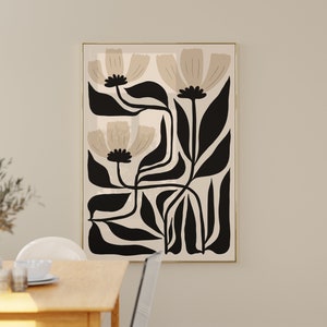 May include: A framed abstract art print featuring stylized beige flowers with black stems and leaves on a beige background.