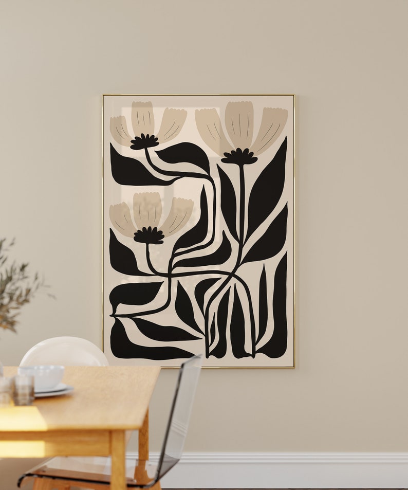 May include: A framed abstract art print featuring stylized beige flowers with black stems and leaves on a beige background.