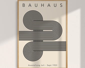 May include: A framed Bauhaus art print. The print features the word "BAUHAUS" at the top, with a black and white geometric design of curved lines and circles. The text "Ausstellung Juli - Sept 1923" is at the bottom.