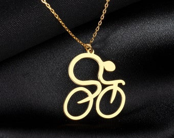 Könnte beinhalten: Eine goldene Halskette mit einem Anhänger in Form einer Person, die Fahrrad fährt.