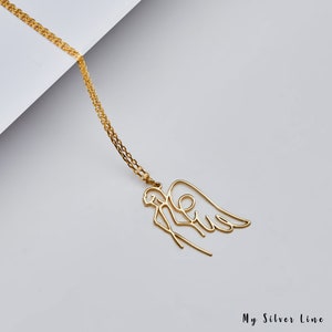 May include: A gold necklace with a delicate angel pendant. The angel is depicted in a single line drawing style with wings outstretched.