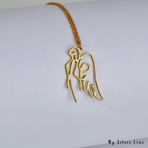 May include: A gold-toned necklace with a delicate, single-line design of an angel with wings. The necklace is on a white background.