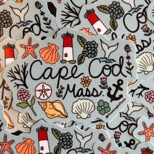 May include: A collection of stickers with a light blue background, featuring the words "Cape Cod Mass" in a cursive font. The stickers are decorated with illustrations of seashells, starfish, lighthouses, and flowers.