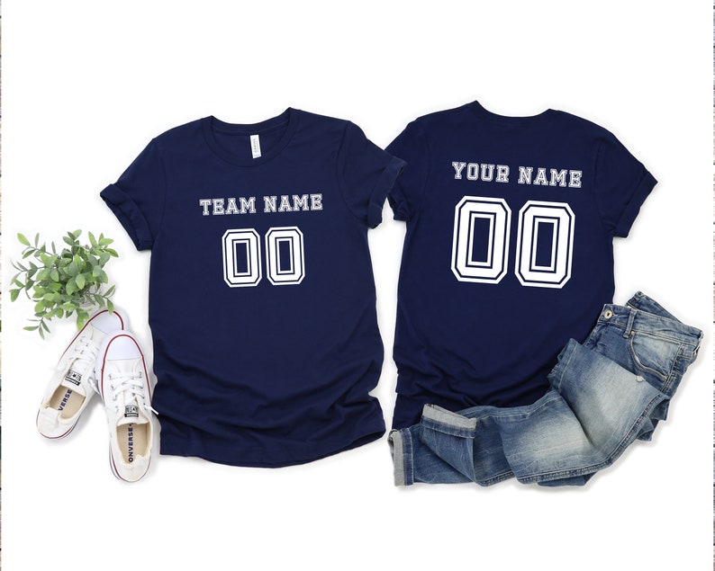 May include: Two navy blue t-shirts with white text and numbers. The front shirt says "TEAM NAME 00" and the back shirt says "YOUR NAME 00".