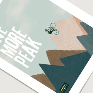 May include: A white graphic with the text "One More Peak" and a silhouette of a person riding a bicycle over a series of brown, beige, and blue mountains. The text "Single Track" is in the lower right corner.
