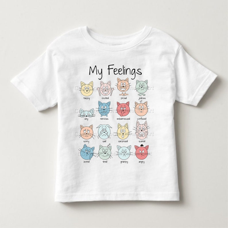 May include: White t-shirt with the text "My Feelings" and a grid of 16 cartoon cat faces, each with a different expression, and the corresponding emotion word below each cat. The emotions are: happy, excited, proud, jealous, shy, nervous, embarrassed, confused, sorry, sad, surprised, scared, bored, tired, grumpy, and angry.