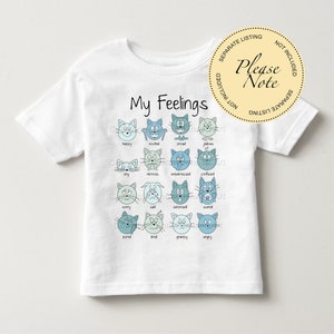May include: White t-shirt with a blue and white illustration of cat faces with different emotions. The text "My Feelings" is printed above the illustration. The text "Please Note" is printed on a yellow circle.